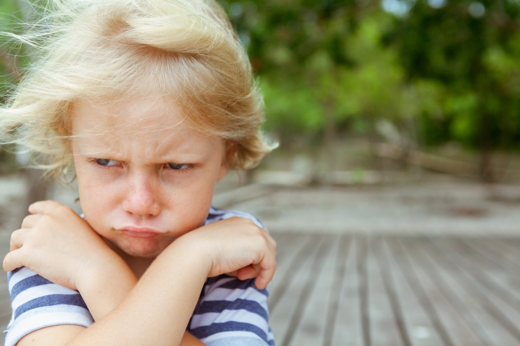 Creepy and unhappy Caucasian -winged children with crossed wings with copy space
